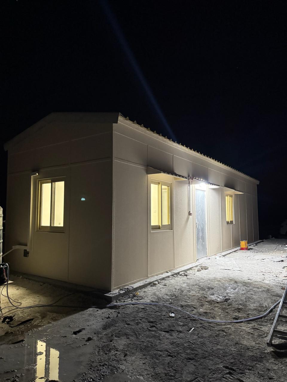 Prefab cabin delivered and installed on site at night